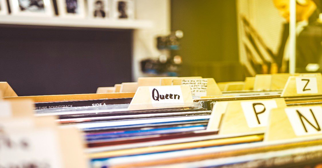 An image of a record collection sorted alphabetically. You can see labels for "P", "N", "Z", and the name "Queen".