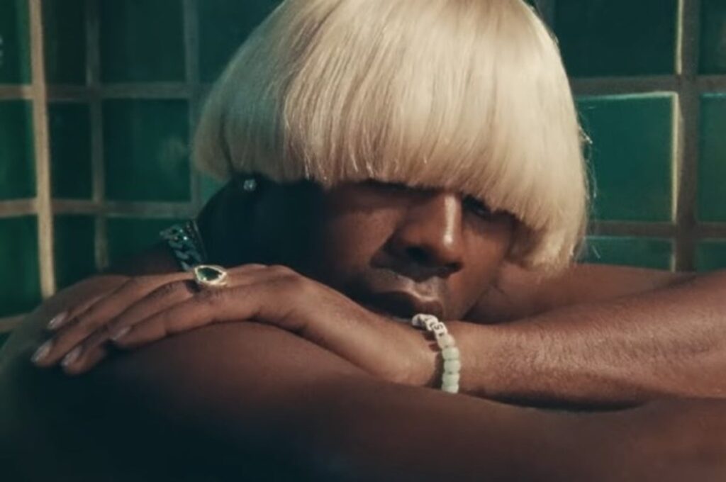 A screenshot from the music video of Tyler the creator Igor "A BOY IS A GUN*"